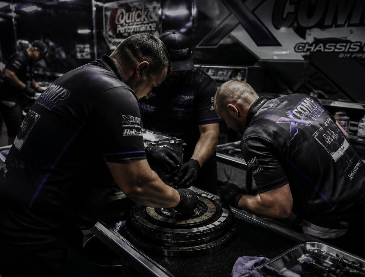 Crew servicing a Top Fuel clutch pack between runs